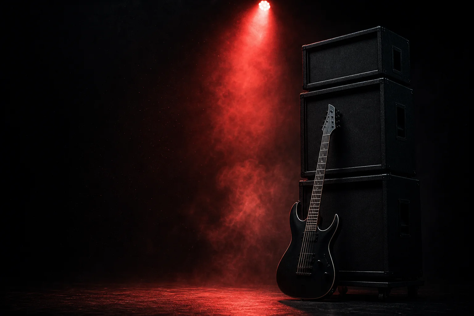 Black electric guitar against amplifiers under a red spotlight, evoking Hardwired to Self-Destruct's thrash metal sound