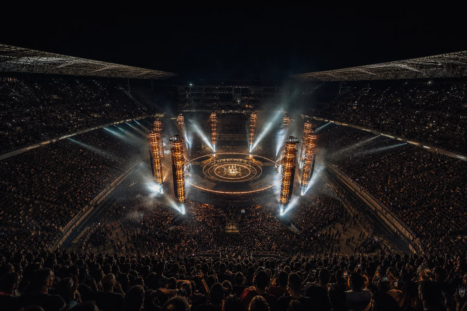 Circular in-the-round stage glowing in a packed night stadium, evoking the Metallica M72 World Tour