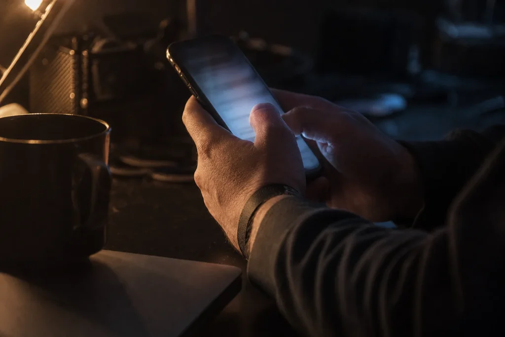 Fan holding a smartphone at night, ready to tap the moment a concert ticket presale opens